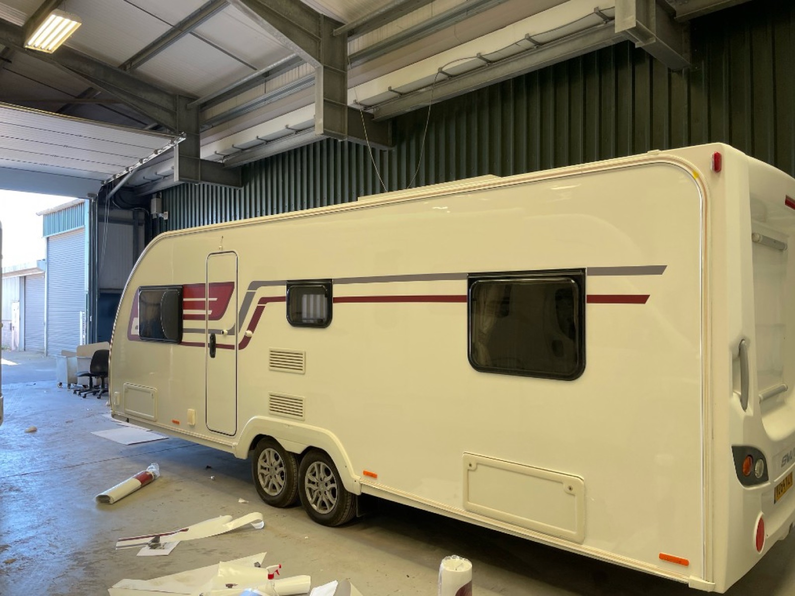 Swift caravan with custom vinyl stripe graphics fitted in workshop