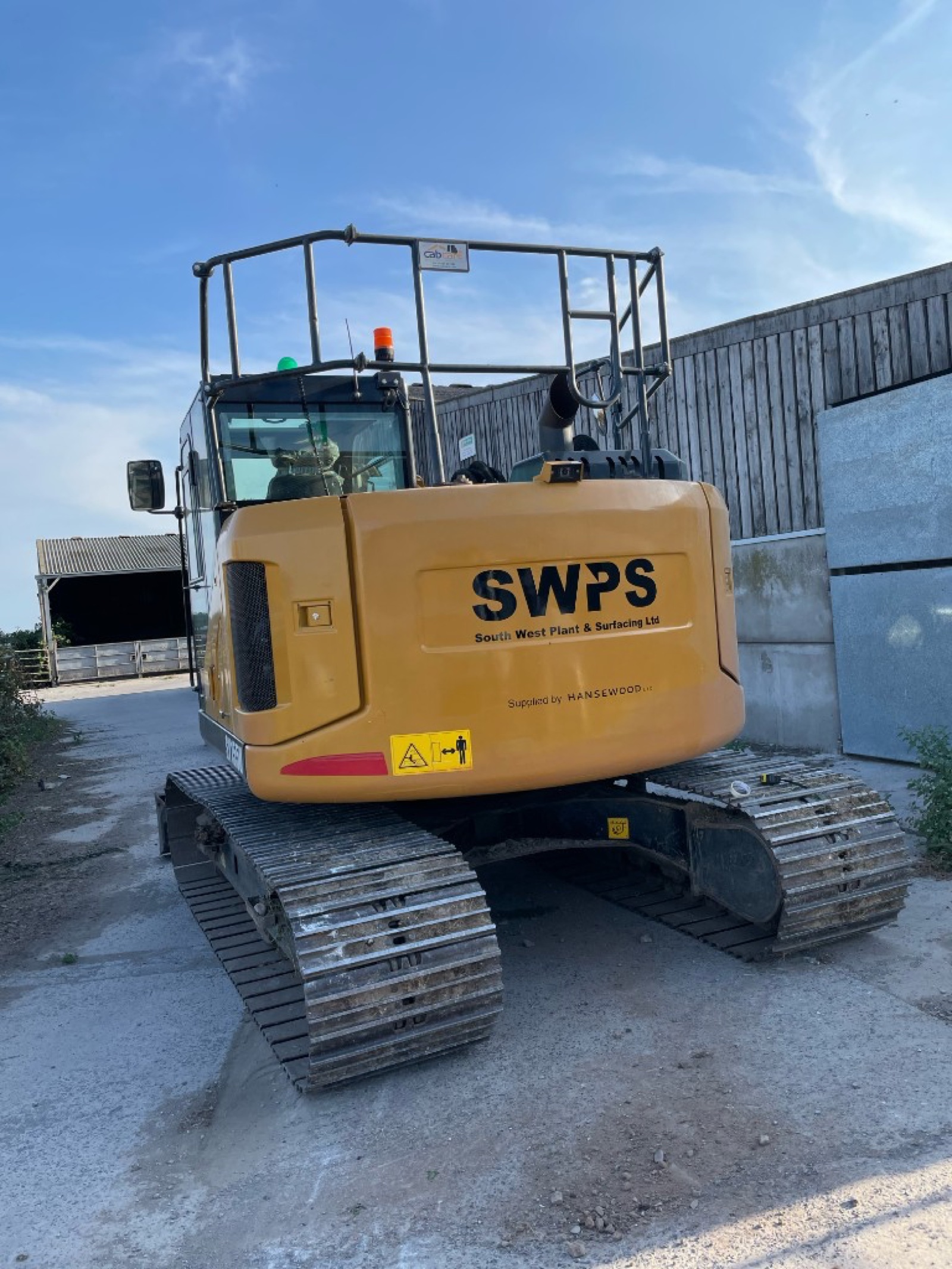 SWPS South West Plant & Surfacing excavator with vinyl fleet graphics