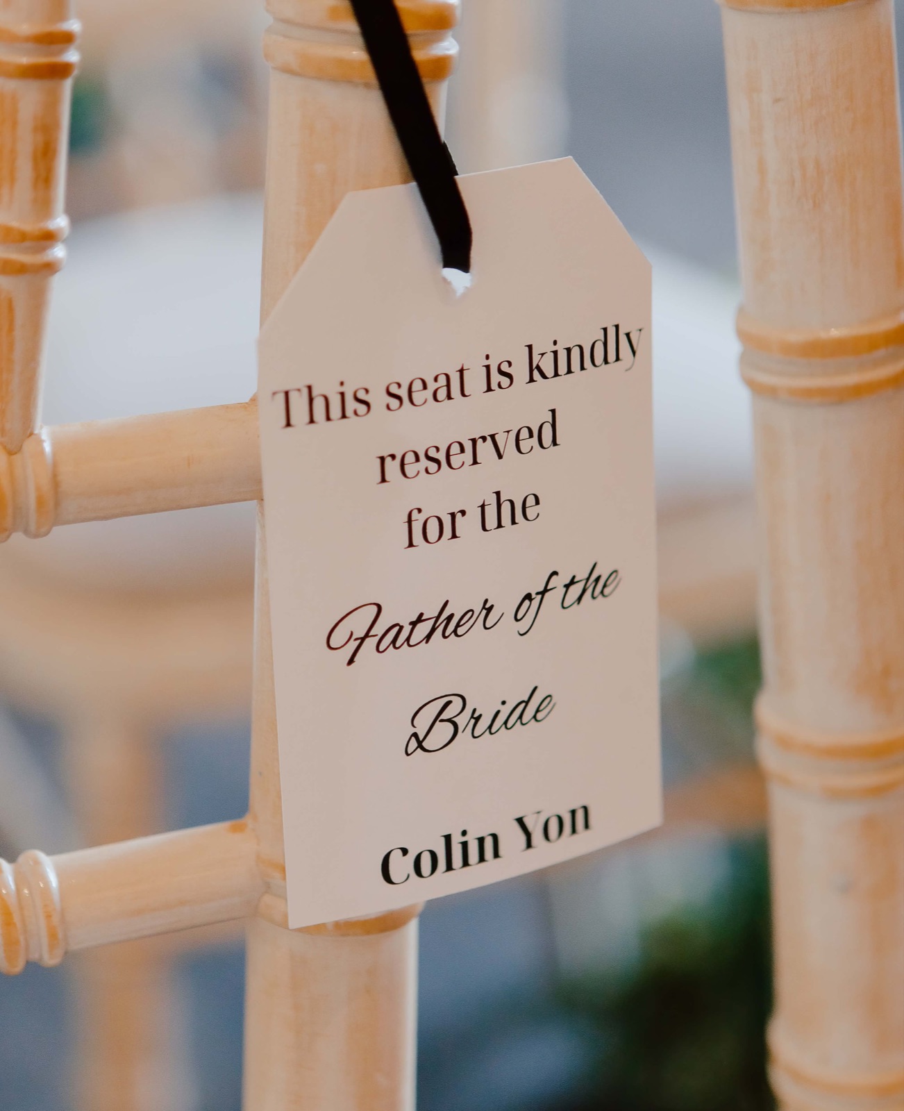 Chair tag reading “This seat is kindly reserved for the Father of the Bride”