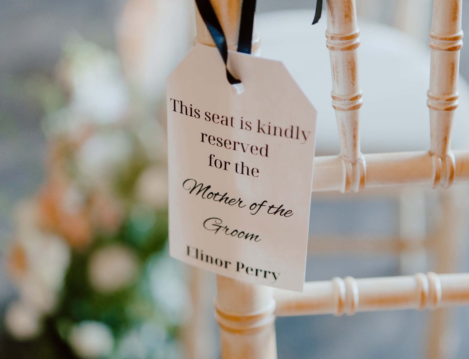 Chair tag reserved for the Mother of the Groom hanging from a chair
